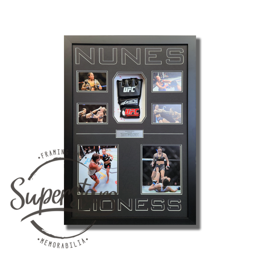 Amanda Nunes signed UFC glove is surrounded by action photos with the words Nunes across the top. The word Lioness is along the bottom. It has a black timber frame, black wording and black borders. UFC has been embossed between the two larger photos.