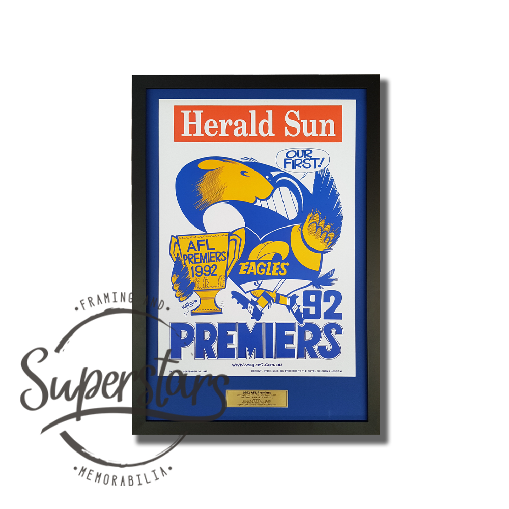 A poster celebrating the Eagles winning the AFL Premiership in 1992. It has been framed with a blue border and black timber frame. It also has a plaque