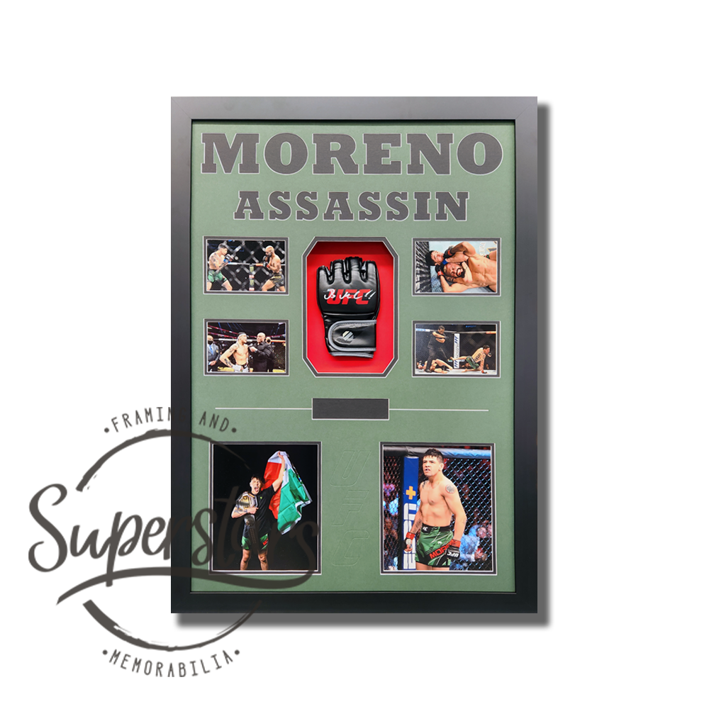 Brandon Moreno signed UFC glove is surrounded by action photos with the words Moreno Assassin across the top. It has a black timber frame, black wording, army green borders and black trim line. UFC has been embossed between the two larger photos.