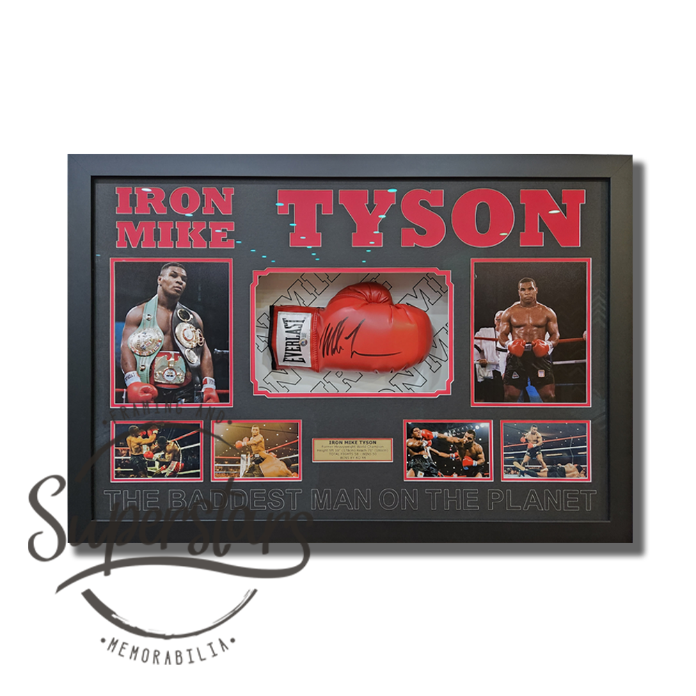 A red everlast glove signed by Mike Tyson is mounted in front of a custom matboard and surrounded by colour photos of Mike in action. Across the top is red word art that reads Iron Mike Tyson. There is a gold plaque. Across the bottom it reads 'the baddest man on the planet'.