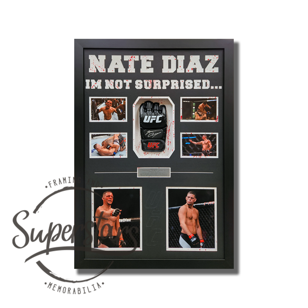 A large black frame, displays a black UFC glove that has been signed by Nate Diaz in silver ink. It is surrounded by action photos. Across the top it reads "Nate Diaz I'm Not Surprised..."