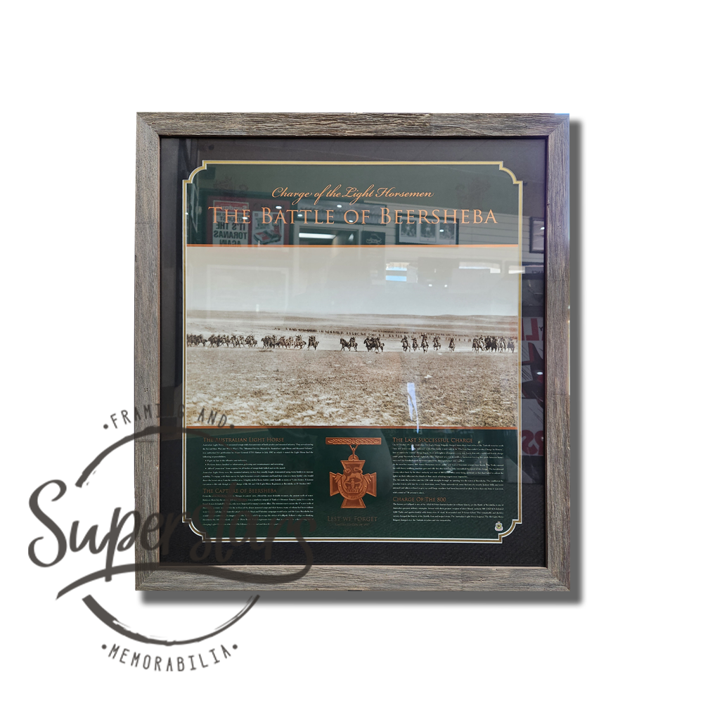 Australian history at it's best. A grey wooden frame, that is textured to look like it is weathered, surrounds a dark green poster that details with text and one large sepia image. It also includes an embossed replica medal.