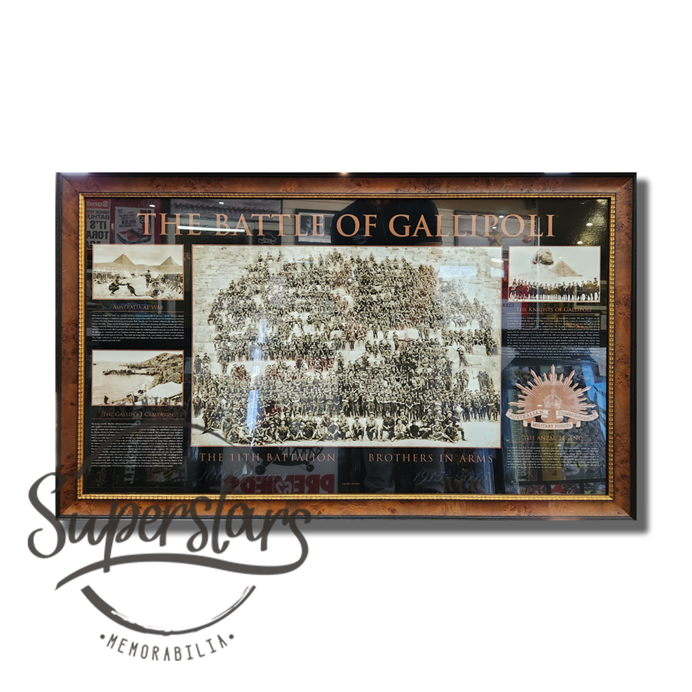 A timber light wooden frame with a dark brown trim surrounds a poster that details with historical photos and wording the story of the 11th Battalion.
